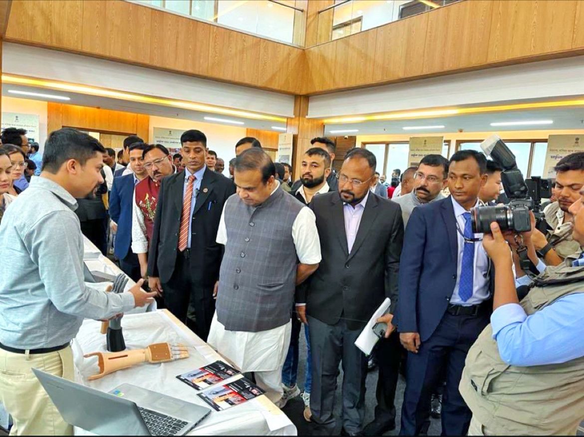 Symbica demonstrating the prosthetic hand to visiting dignitaries
