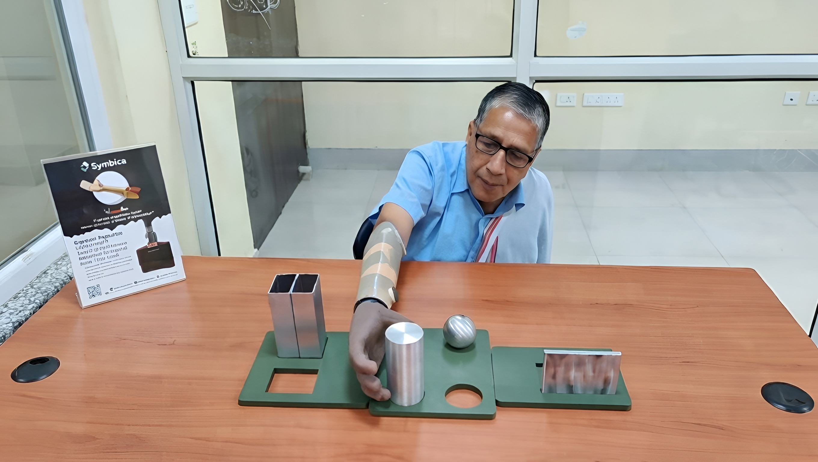 A user performing grasp tests with the Symbica prosthetic hand