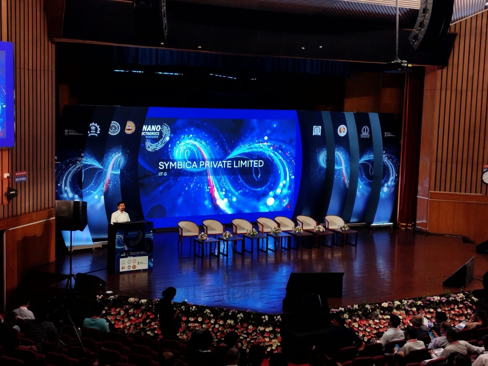 Symbica presenting on stage at the Nano Electronics Roadshow, IIT Guwahati